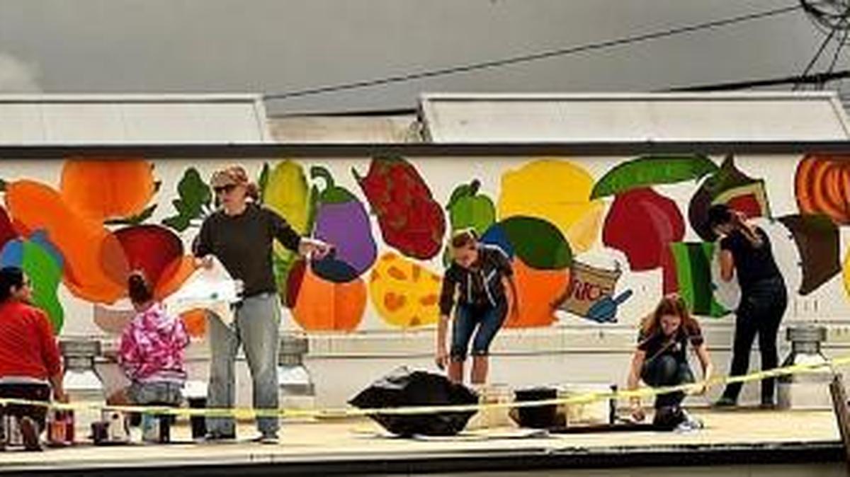 Students from the NOVA School’s Art Program work on the wall-length mural depicting healthful foods and produce on the roof of the Thurston County Food Bank in 2016. The South Puget Sound New Horizons Band will perform in support of the Thurston County Food Bank at 7 p.m. Friday at the Land Yacht Harbor Harmony Hall, 9101 Steilacoom Road SE, Olympia.