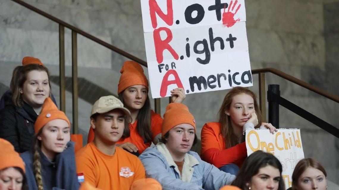 Lydia Ringer, 16, a junior at Roosevelt High School in Seattle, holds a sign that reads “NRA - Not Right for America,” at Tuesday’s student rally against gun violence at the Capitol in Olympia.