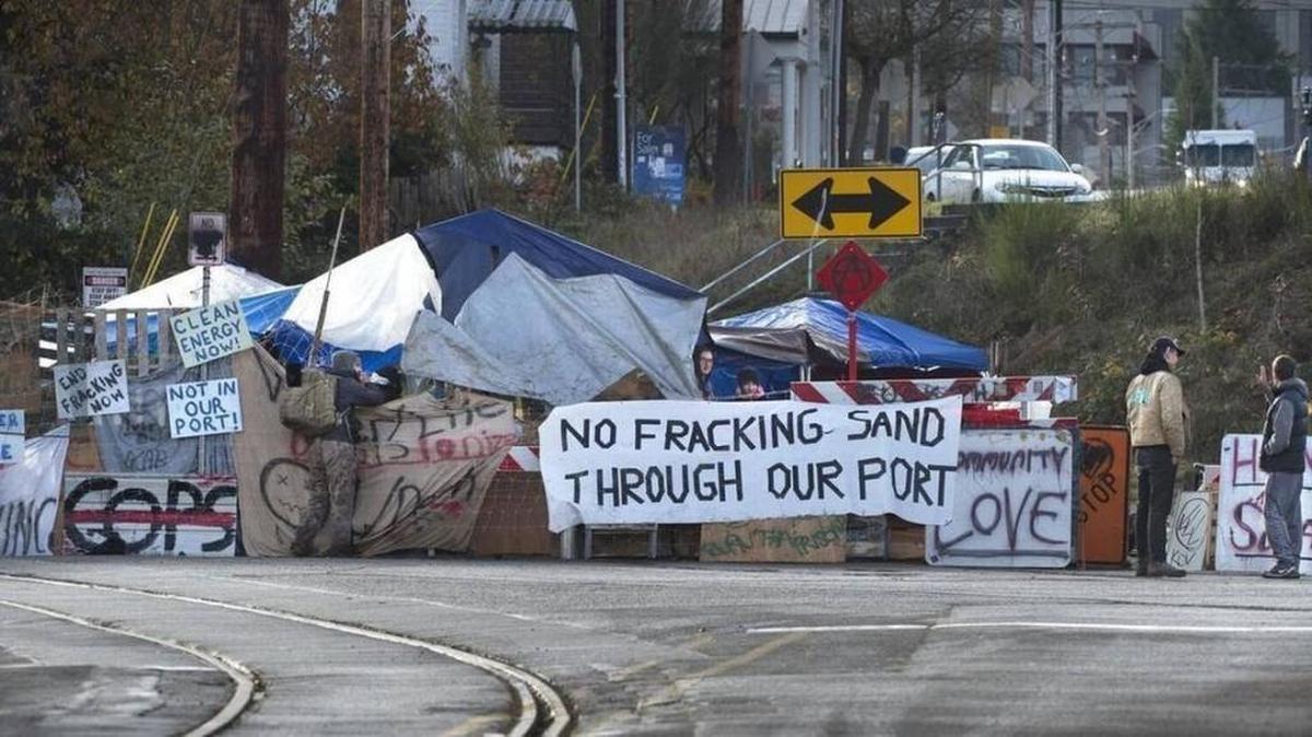 An anti-fracking group blocks the railroad tracks from the Port of Olympia in downtown Olympia on Saturday.