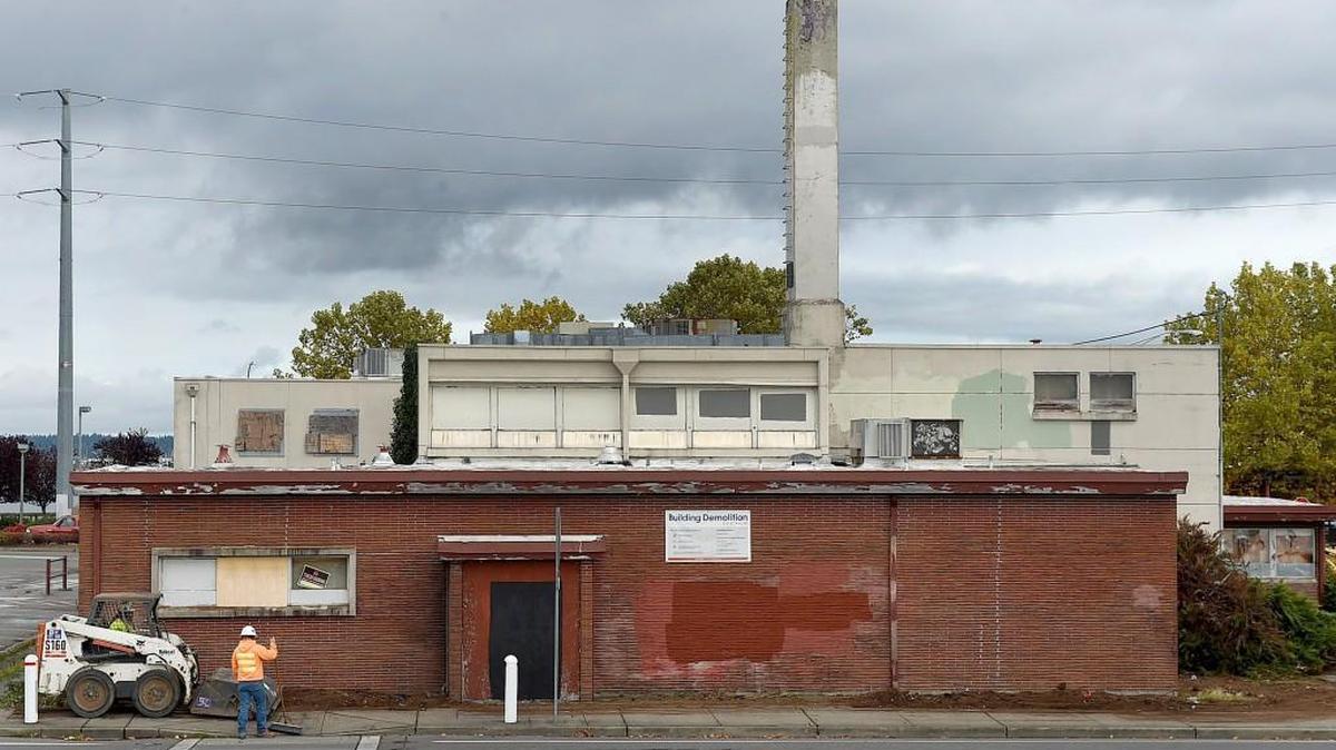 A work crew cleans and clears the perimeter around the vacant Thurston County Health Department building Oct. 19 as the City of Olympia’s contractor, WM Dickson Co., prepares to begin demolition at 529 4th Avenue West.