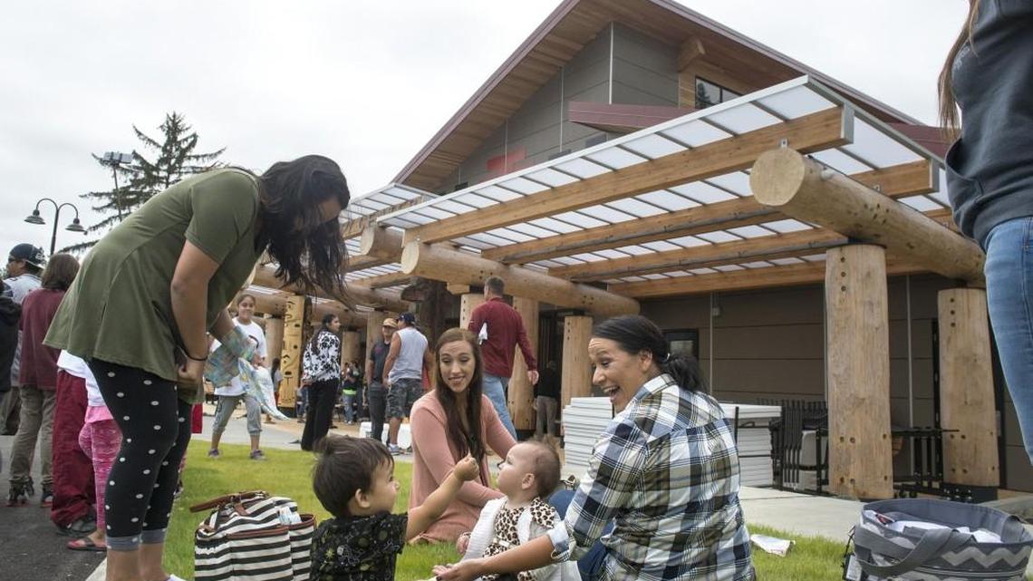 Skokomish Tribal family members relax in the grass outside the Skokomish Tribe’s community center in 2017. The Tribe is getting $1 million from the federal government for affordable housing.