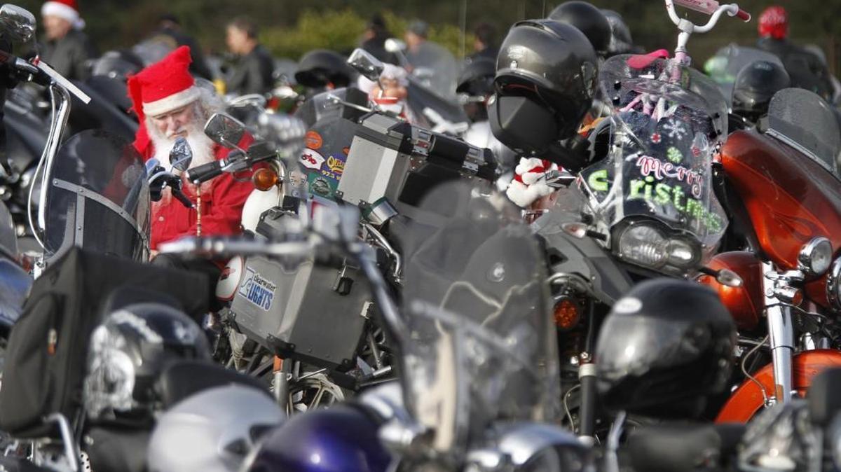 Peter Dodge of Olympia is shown amid hundreds of motorcycles as he waits for the start of the 2014 Olympia Toy Run at South Sound Center in Lacey.