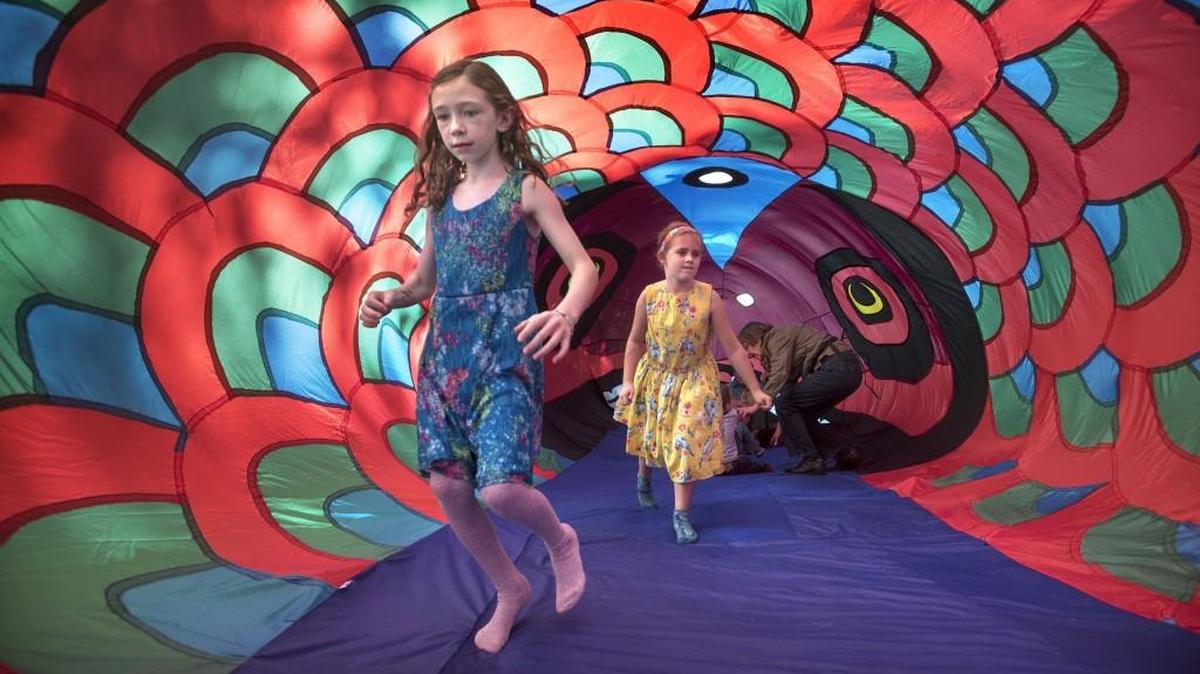 
Hailey Tamerow, left, and Maddie Walsh, both 7, walk through the inflatable 40-foot red salmon tent after listening to storytelling during the 26th annual Nisqually Watershed Festival at the Nisqually Wildlife Refuge on Saturday. Both girls were winners in the Nisqually Refuge’s student-designed poster contest.

