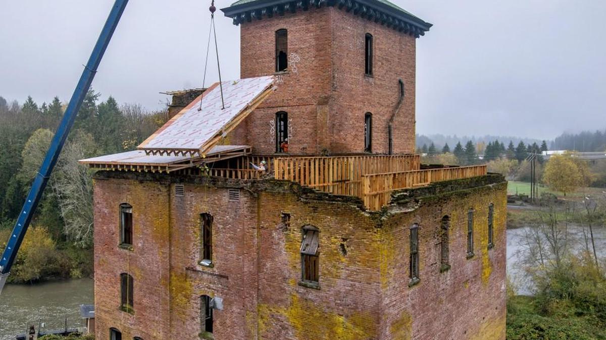 A section of roof is lowered into place atop the old brewery in November. Efforts to preserve the old brewhouse will be discussed as part of the History Talk at the Schmidt House on Thursday.
