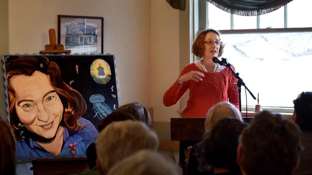 Alice Derry reads “Belated Poem in the Voice of the Pond” written by Lucia Perillo during the Celebration of life for the noted Olympia poet Dec. 11 at the Woman’s Club of Olympia.