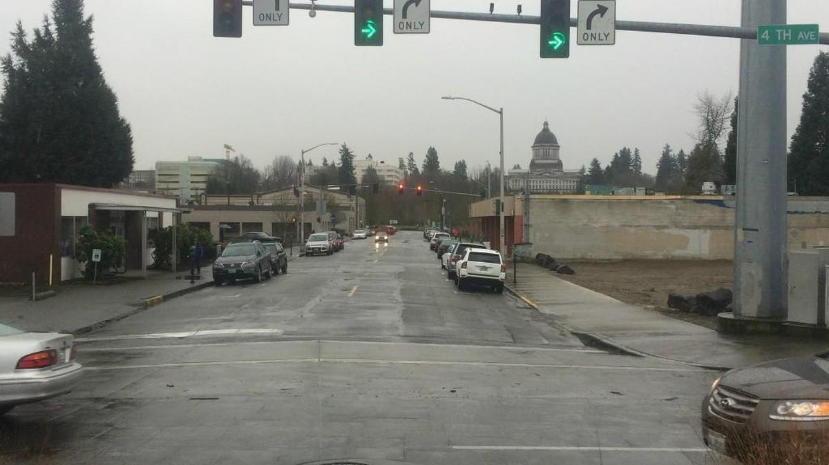 Water Street in downtown Olympia, as seen from the intersection at Fourth Avenue. In December, a contractor razed two-city owned buildings at the northwest corner, leaving behind an empty lot.