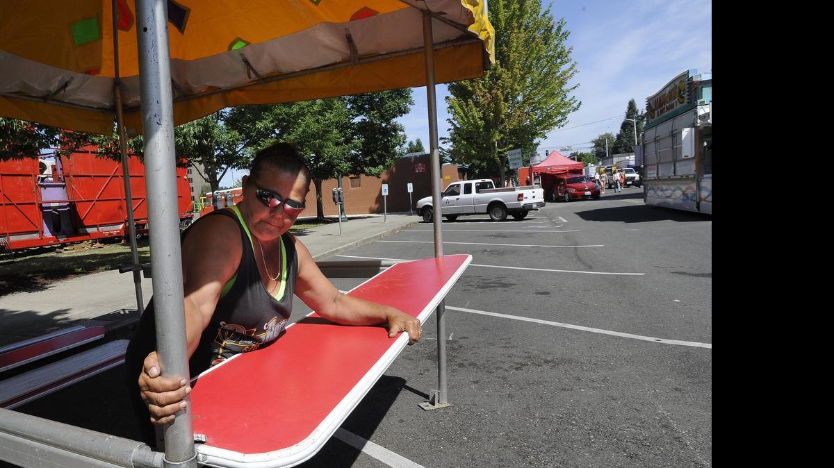 
Darla Baker sets up her snow cone booth in the Funtastic Traveling Show vendor's area in preparation for the 58th annual Capital Lakefair.
