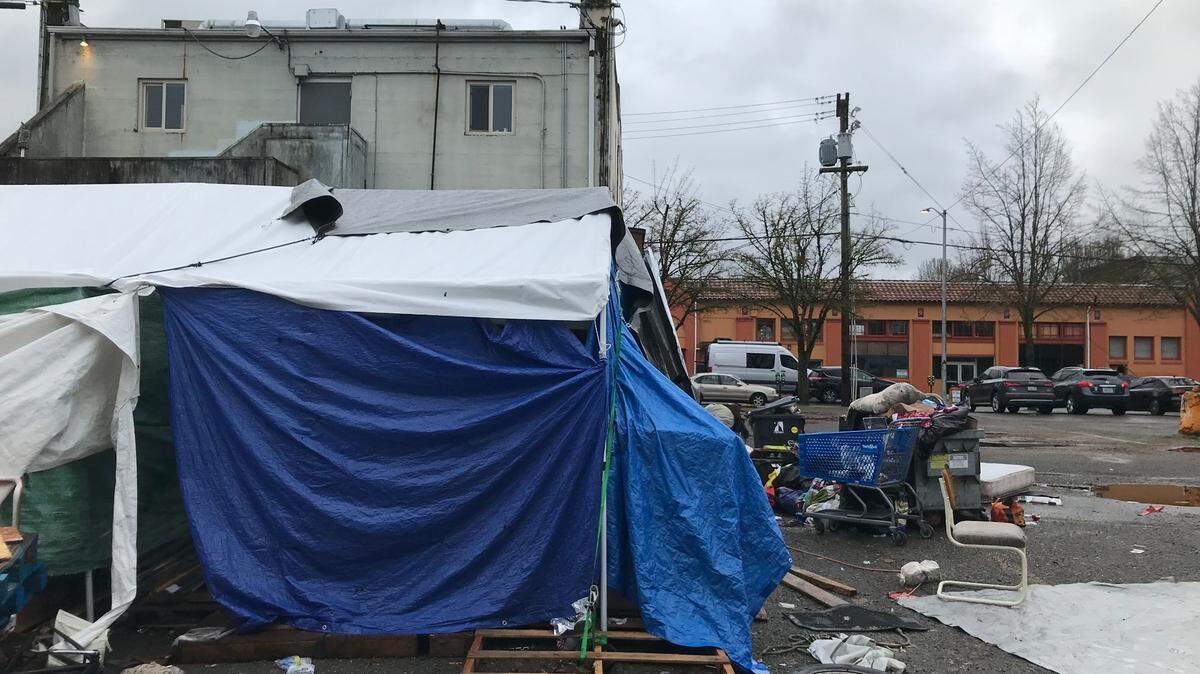 A homeless encampment in a downtown Olympia parking lot has instigated a legal standoff btween the city and Stonewall Youth, a nonprofit that serves LGBTQ youth.