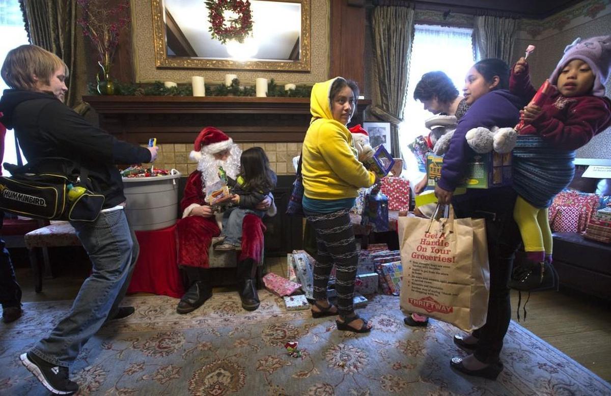 Families visit with Santa Claus and pick out kids Christmas presents during the annual holiday distribution day at the YWCA in Olympia in 2016.