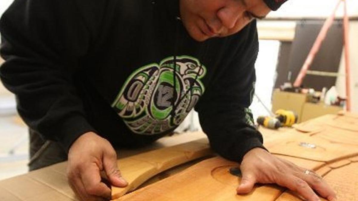 
Skokomish tribal artist John Edward Smith finishes some detail work on his Salish sea serpent before its installation in 2013 in The Evergreen State College Longhouse’s Carving Studio. Smith will be one of the Northwest carvers joining Maori artist Lyonel Grant during an art dedication for the college’s new Fiber Arts Studio, which will be part of Evergreen’s Indigenous Arts Campus, and is slated to open in 2016. 
