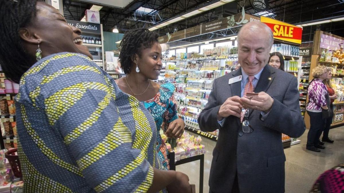 Ahoumondom Bamassi, left, and Mawule' Houmey hare a few laughs with University Place mayor Javier Figueroa by the Alaffia products display at Whole Foods Market Chambers Bay in University Place on Tuesday, Mar. 8, 2016.