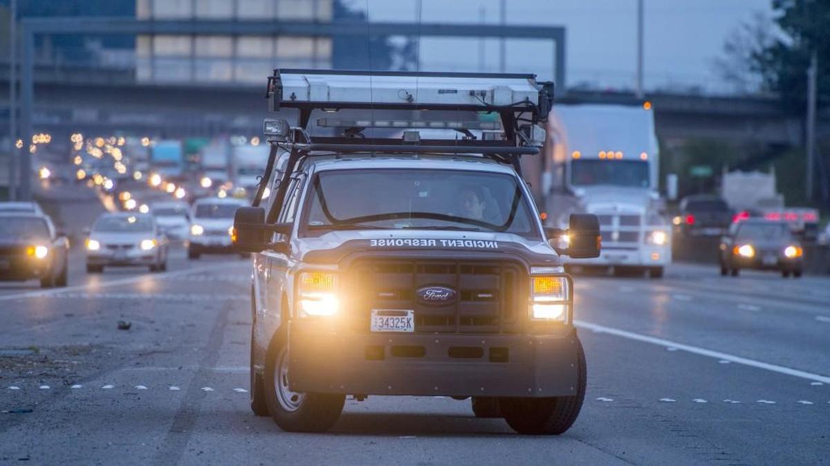 Brian Farrar of the state’s Department of Transportation’s Incident Response Team sits Monday in his vehicle away from traffic on the shoulder of Interstate 5 in Tacoma