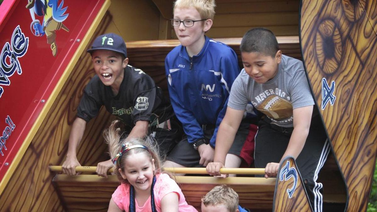 Mason Bell (from left), 10, Ammon Kollecker, 12, and Jakobe Bell, 9, hang on to the "Pirates Revenge" thrill ride during the 2015 Lacey Spring Fun Fair on the Saint Martin's University campus in Lacey.