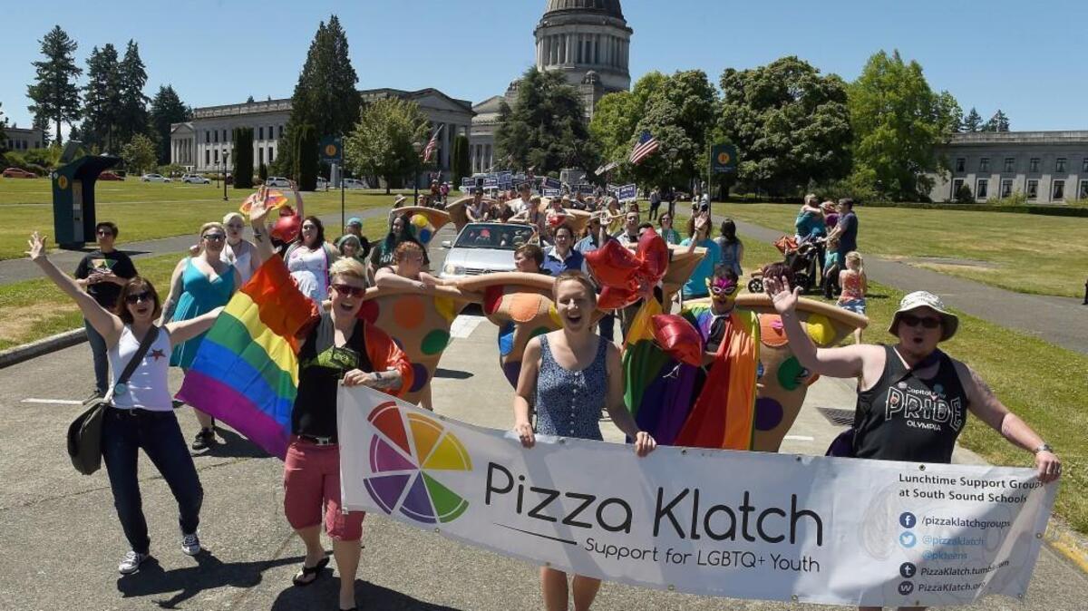 FILE PHOTO: The Pizza Klatch contingent makes its way from the Capitol Campus onto Capitol Way for the Capital City Pride Parade.