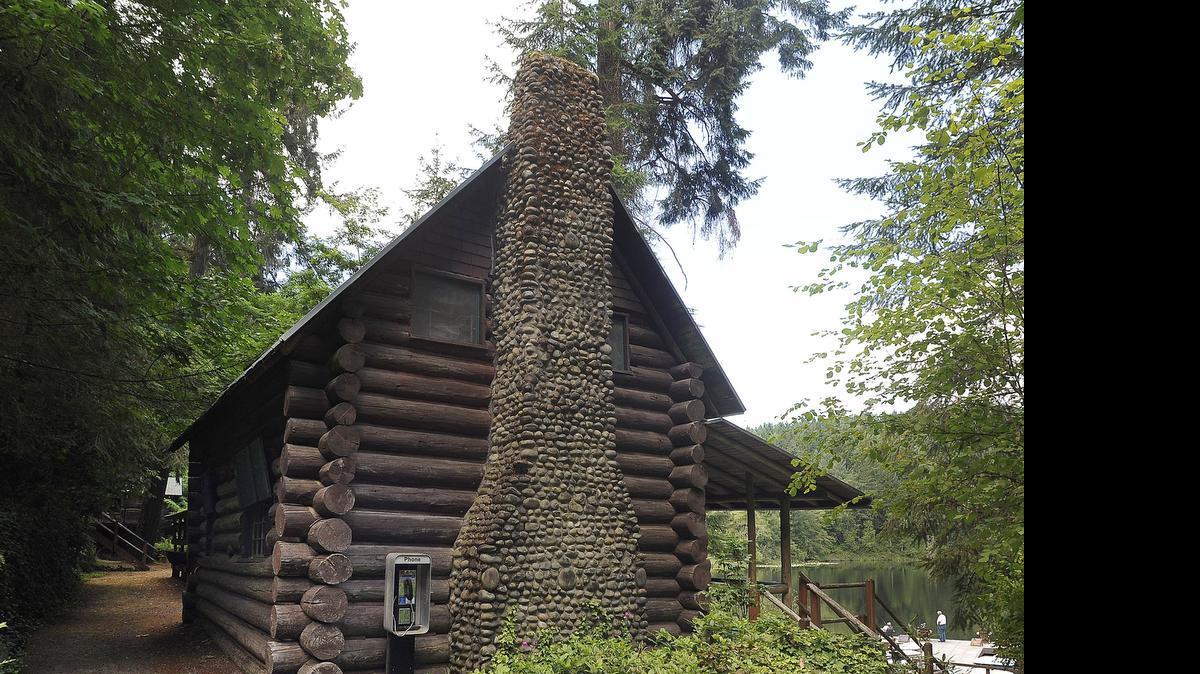Rich wood tones coupled with a striking stone chimney highlight the 100 year-old lakefront cabin at Lost Lake Resort near Nisqually, which was recently added to the county historic register.