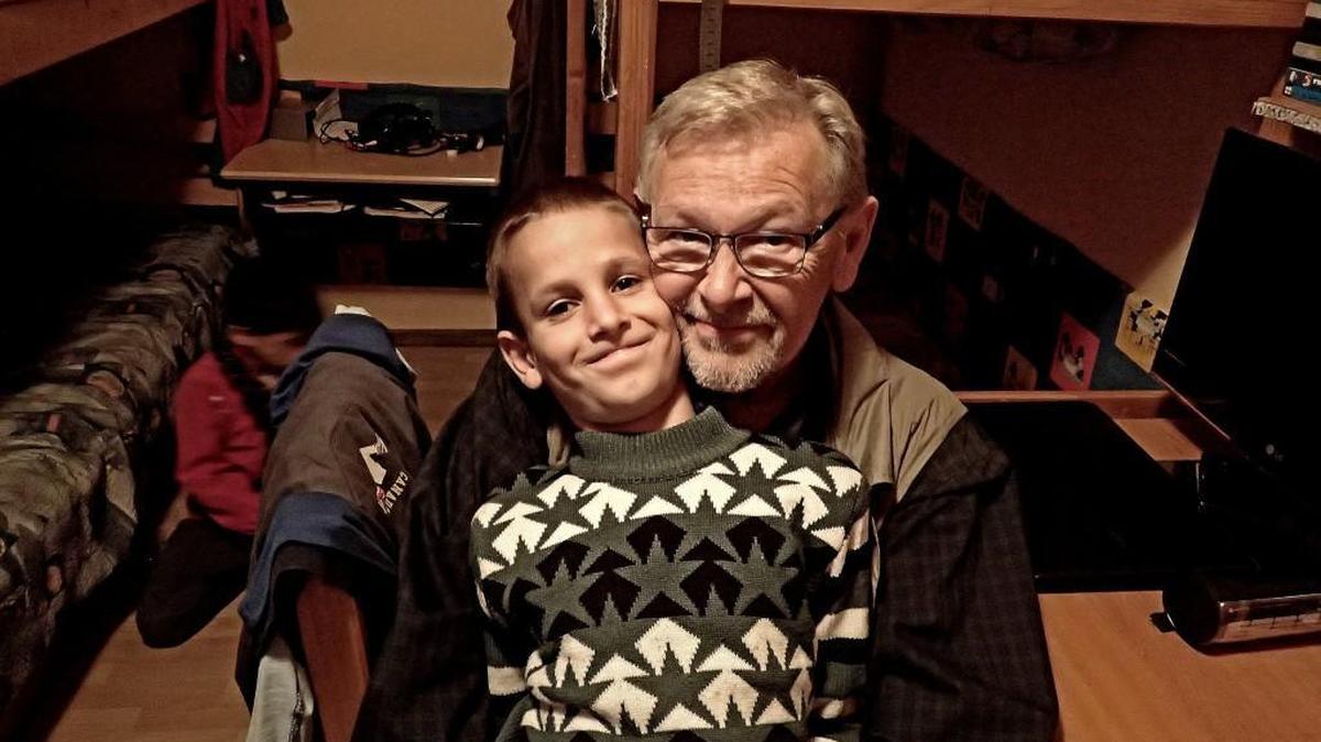 Staff writer C.R. Roberts meets a new friend at the Cernatul de Sus Orphanage located near Brasov, Romania, on Sept. 30, 2015. A group of Americans traveled in September to Romania to visit homes that benefit orphans and abandoned children. The nonprofit Kidstown International of Bellingham, Washington, and Tacoma Rotary 8 help fund the homes.