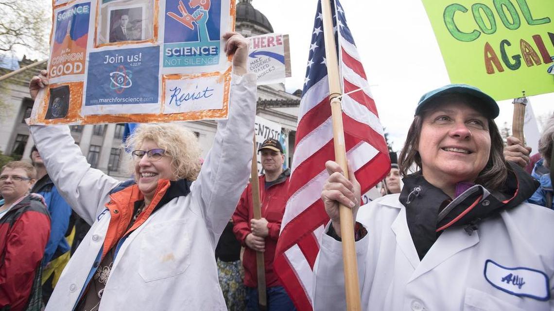 South Puget Sound Community College physics instructor Kathleen Ensenat (left) and Department of Ecology worker Kasia Pierzqga, both of Olympia, join approximately 5,000 supporters of science during the March for Science rally on the Capitol Campus in Olympia in 2017.