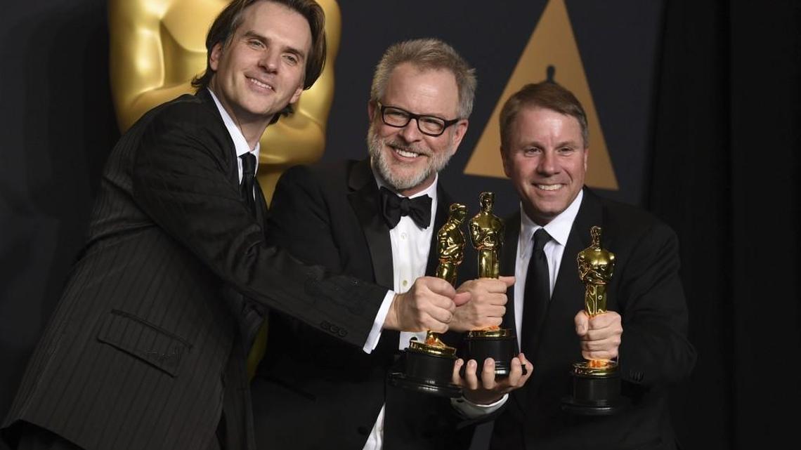 Byron Howard, from left, Rich Moore and Clark Spencer pose in the press room with the Oscar for best animated feature for “Zootopia” at the Academy Awards on Sundayat the Dolby Theatre in Los Angeles.