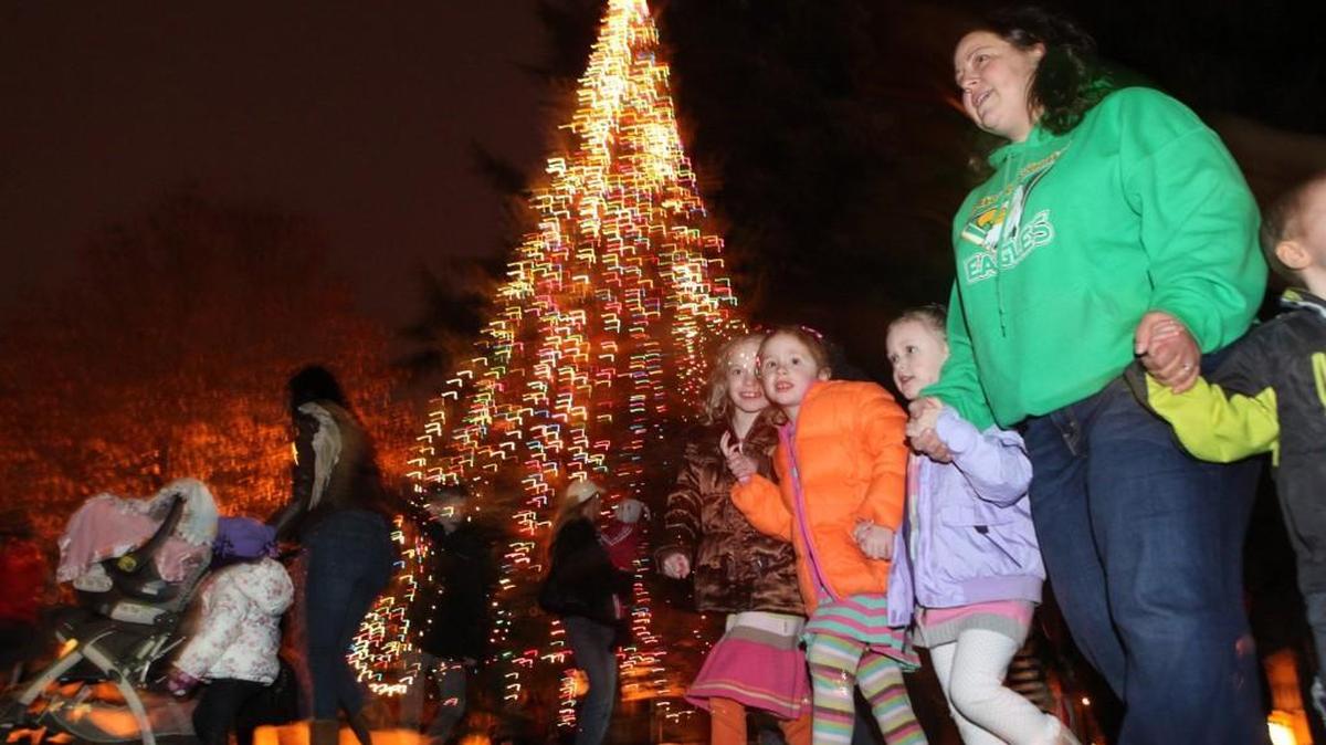 FILE PHOTO: Kids gather around the Christmas tree as they wait for the arrival of Santa Claus during the City of Tumwater's annual Christmas tree lighting celebration in 2012.