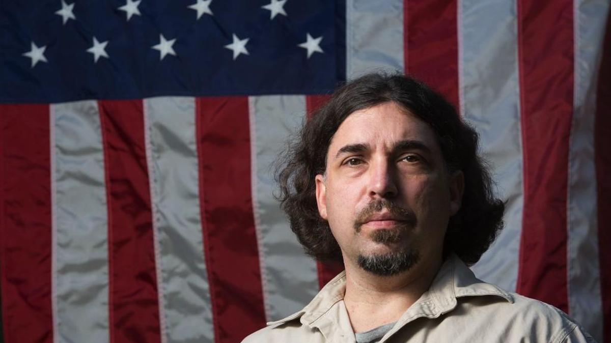 Brian Browne, 45, stands in front of one of the many flags he collects at his home on Tuesday, Sept. 27, 2016, in Everett. Browne, who turned in an U.S. flag raised at ground zero on Sept. 11 to Everett firefighters, has been identified. The Daily Herald reports that Browne, had seen the coverage of the flag’s return to New York earlier this month and contacted authorities.