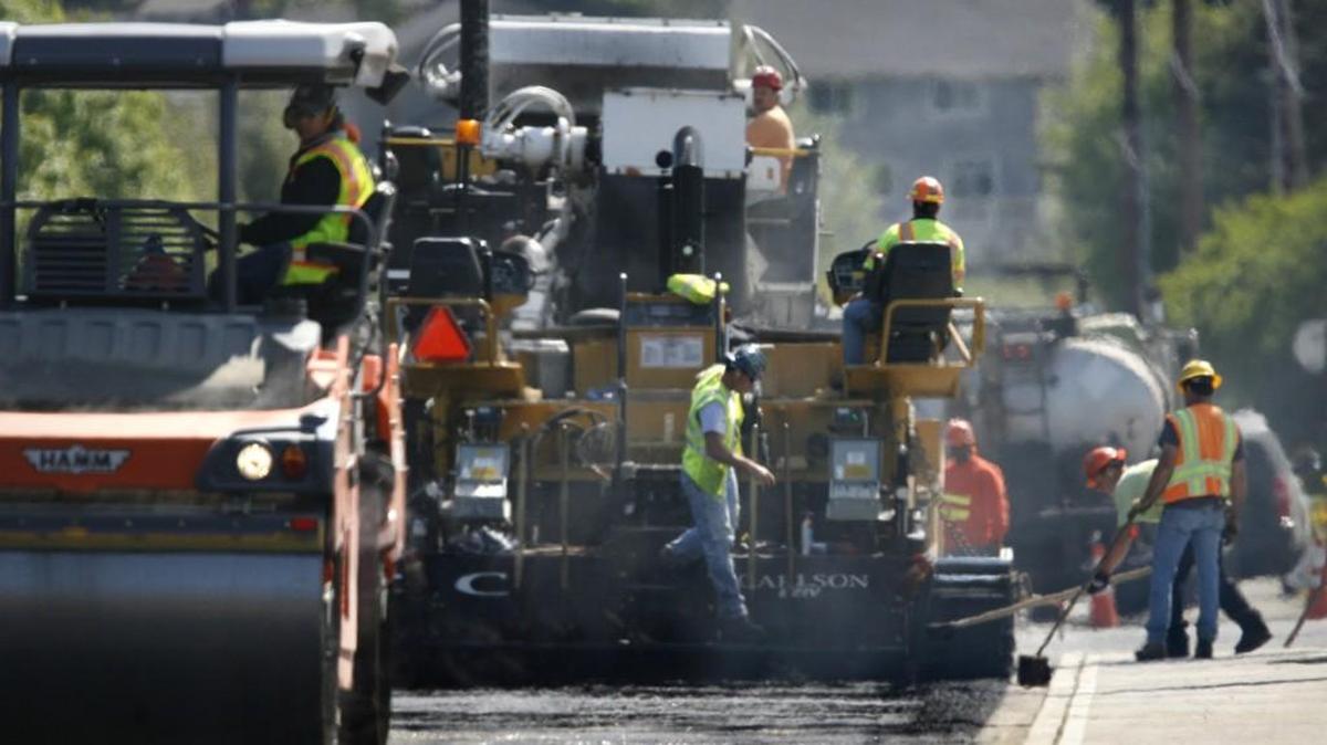 Paving crews lay new asphalt on Yelm Highway near the Wiggins Road intersection in 2012. A summer resurfacing project on Old Highway 99 will stretch from the Thurston-Lewis County line to Tenino.