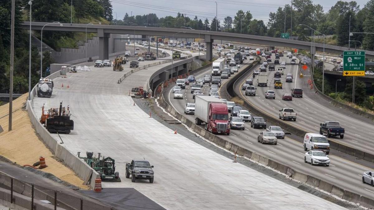 A wide strip of new concrete awaits striping on a newly built northbound Interstate 5 bridge over I-705. The bridge is expected to open to traffic following the July Fourth holiday.