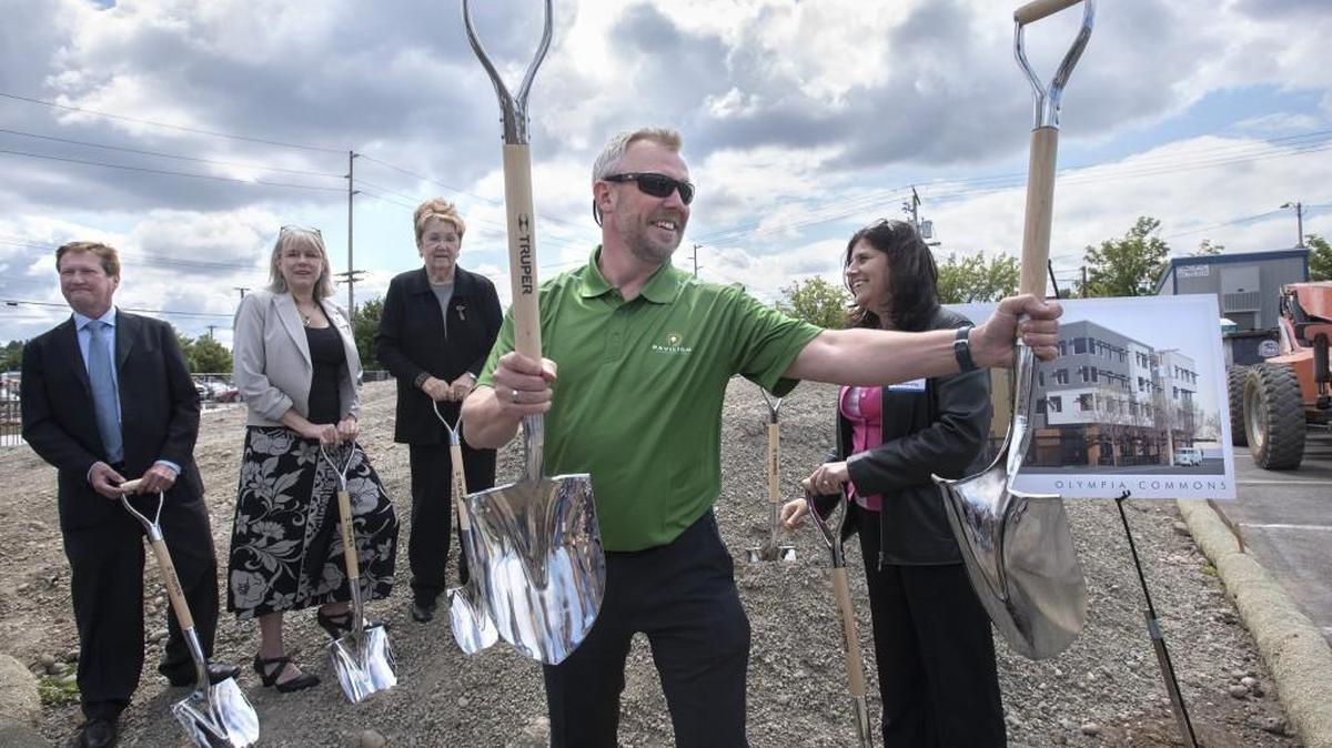 Brian Gerritz, president of Pavilion Construction, passes out shovels for the ceremonial groundbreaking of the Low Income Housing Institute’s 43-unit Billy Frank Jr. Place apartments in downtown Olympia on Friday, May 27, 2016.