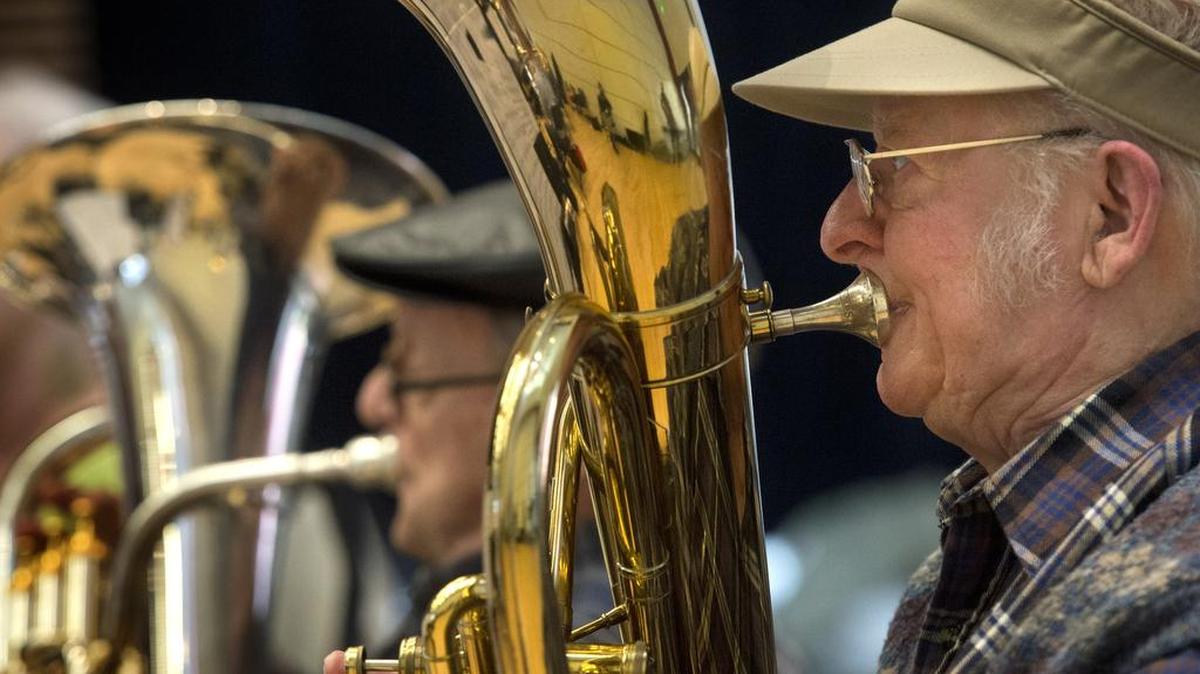 New Horizons Band baritone player Charles Caley, 94, concentrates on playing the music during practice in 2014. The New Horizons Band will perform its annual free spring concert Wednesday morning at the Land Yacht Harbor Harmony Hall.