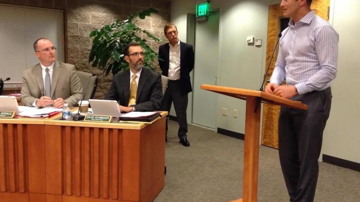 Jonathan Hopkins (right), operations and logistics manager for Uber in Washington state, answers questions from staff and Lacey City Council Thursday night.