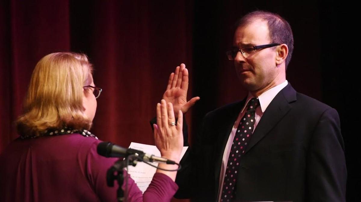 Thurston County Superior Court Judge John Skinder is sworn in by Auditor Mary Hall during the 2016 swearing-in ceremony for Thurston County elected officials at South Puget Sound Community College. City officials and others elected in November in Thurston County will be sworn in Thursday afternoon at SPSCC.