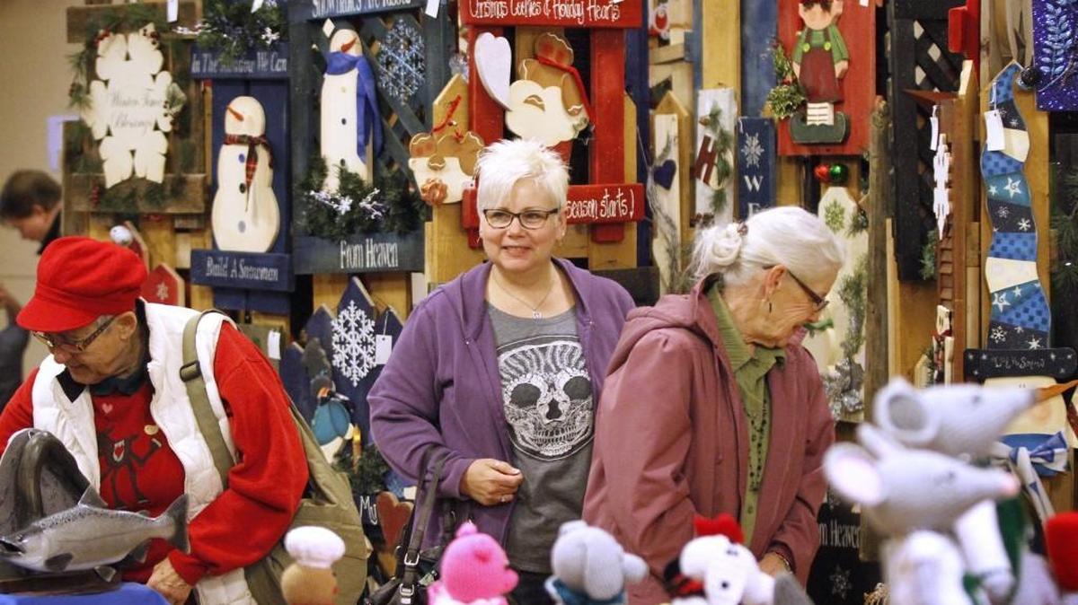 Jennifer Busselle-Dunn (center) of Lacey shops with her mother, Zona Busselle of Benson, Arizona, during the annual Holiday Bazaar at the Thurston County Fairgrounds in Lacey in 2014.