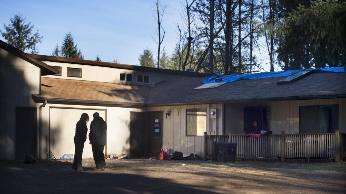 A television news crew stands in front of the house Friday where a dryer fire damaged the Furever Homes animal rescue on Rural Road in Tumwater.