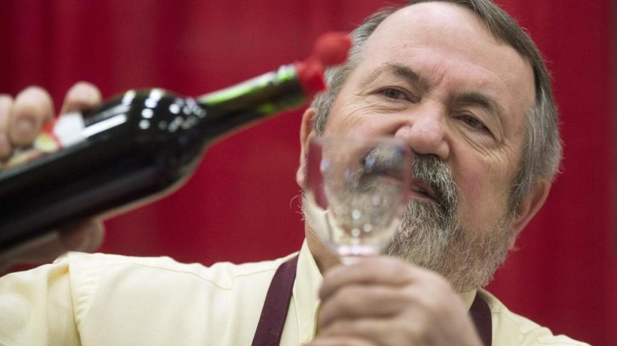 Volunteer Bill Eckroth of Tacoma serves up a sample of Sleeping Dog Wines during the annual Capital Food and Wine Festival at Saint Martin’s University in Lacey. This year’s event is Saturday.