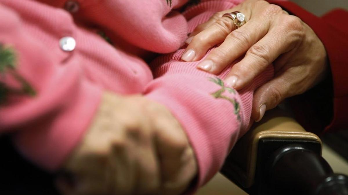 FILE - In this Monday, Feb. 6, 2012, file photo, Alexis McKenzie, right, executive director of The Methodist Home of the District of Columbia Forest Side, an Alzheimer's assisted-living facility, puts her hand on the arm of a resident in Washington. British health secretary Jeremy Hunt on Tuesday, March 17, 2015 announced that major drugmakers, the British government and a top Alzheimer's research charity are pooling more than $100 million to create a global fund to accelerate efforts to find a treatment or even a cure for the mind-robbing disease within a decade. (AP Photo/Charles Dharapak, file)
