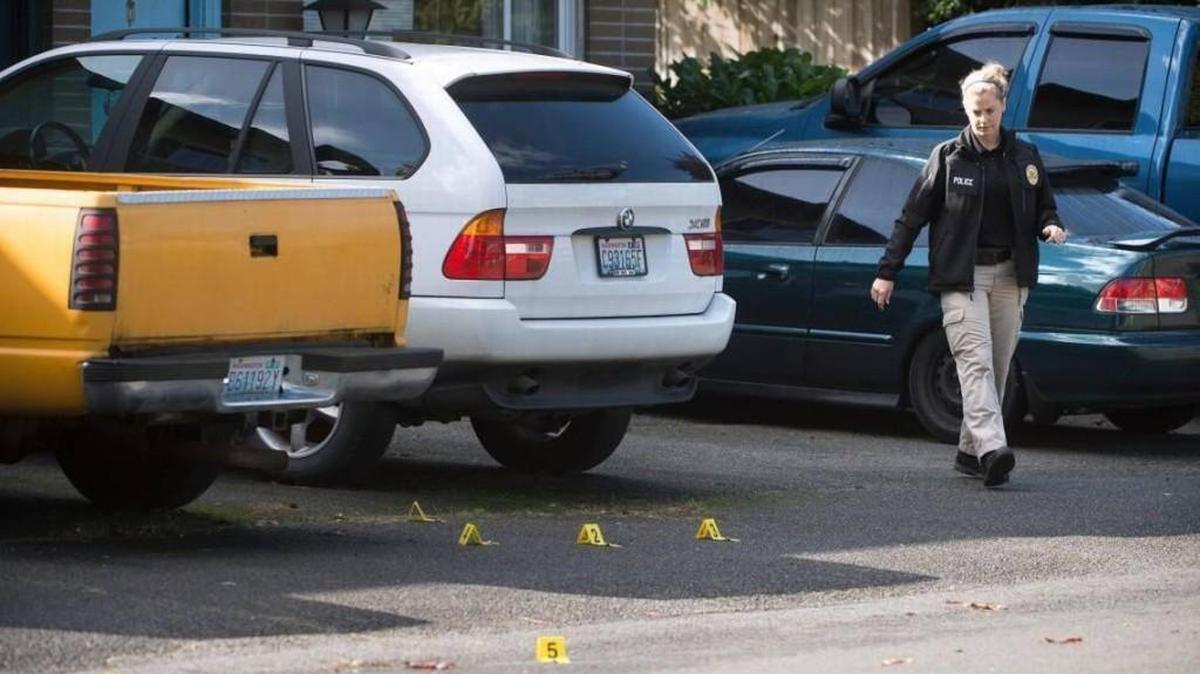 Shell casings are marked with numbered tags as police investigate the scene of a shooting on Forrestal Place Northeast in Lacey on Saturday.