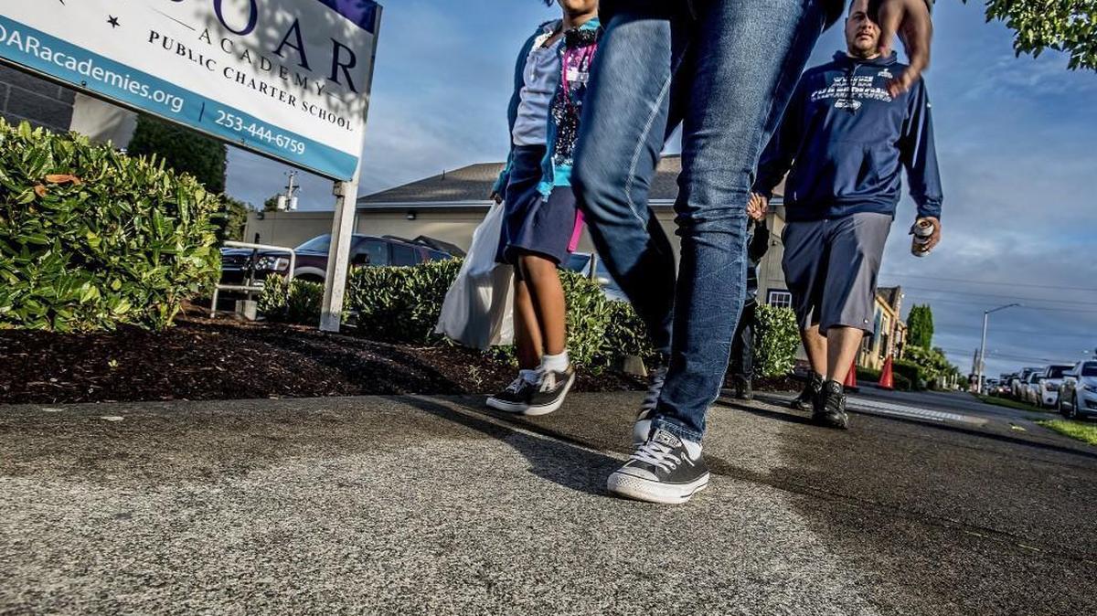 
Alana Thornton, 6, left, holds her mother Jacovia’s hand as they walk to the SOAR Academy, one of three charter schools opening this year in Tacoma. The Washington State Supreme Court ruled 6-3 Friday that the voter-approved charter-school law is unconstitutional. The court said that the privately operated, publicly funded charter schools do not qualify as common schools and thus cannot receive public funding.
