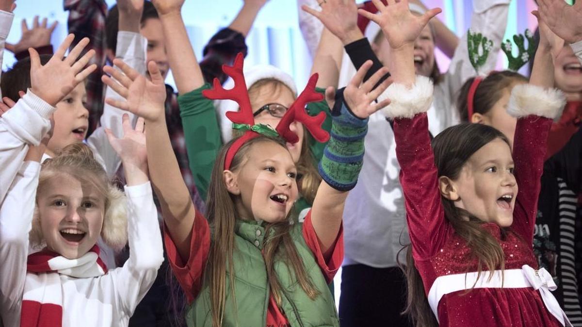Fifth grader Sammy Reed (center), 11, and fellow students from the Michael T. Simmons Elementary School choir perform holiday songs during the 2015 Tumwater Christmas Tree Lighting Festival.