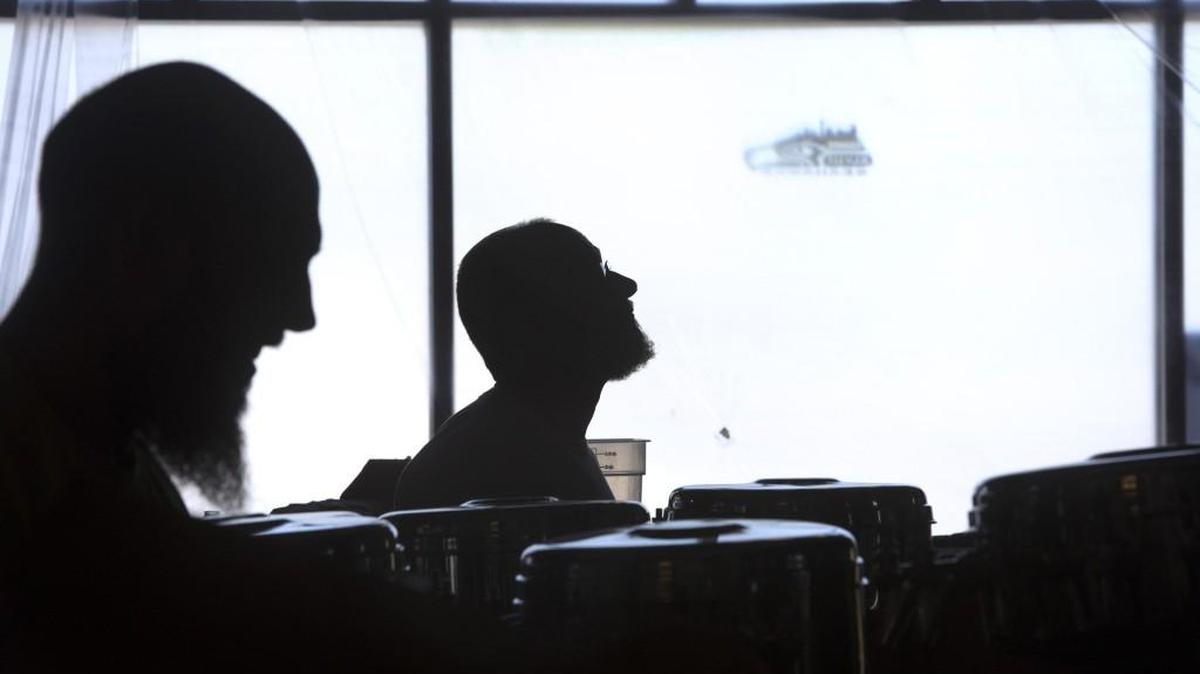 
Zack Thurber (left), a carpenter from Olympia, and general contractor Leif Carne of Olympia work Thursday on the renovation of the Pints & Quarts restaurant and sports bar at the Capital Mall on Olympia’s west side. The bar is planned to reopen on Friday afternoon.
