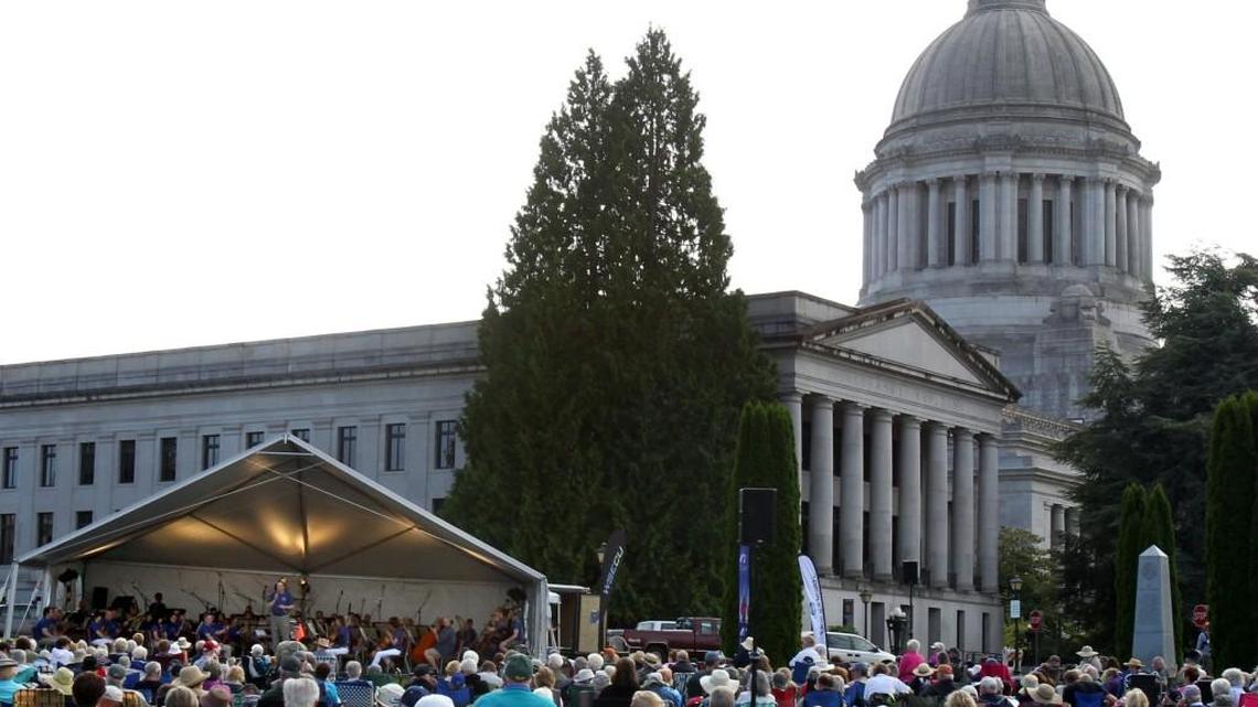 Under light cloud cover but very comfortable weather maestro Huw Edwards directs the Olympia Symphony Orchestra’s 7th annual Concert at the Capitol Sunday afternoon with a musical selection that ranged from Beethoven to John PhilipSousa.The well-attended concert series has become a popular family event, with many making it a enjoyable picnic outing, with the symphony celebrating their 60th anniversary this year.