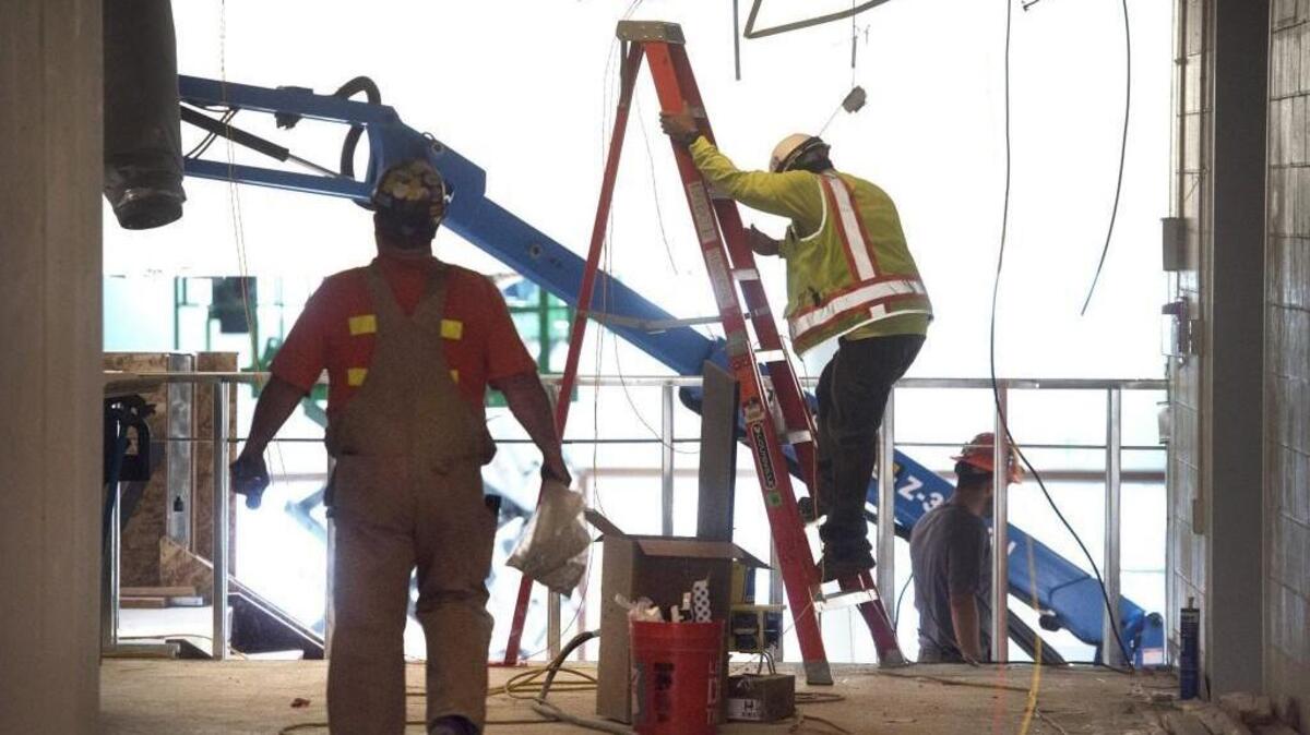 Workers race to finish renovations at North Thurston High School in Lacey before the start of the 2017-18 school year.