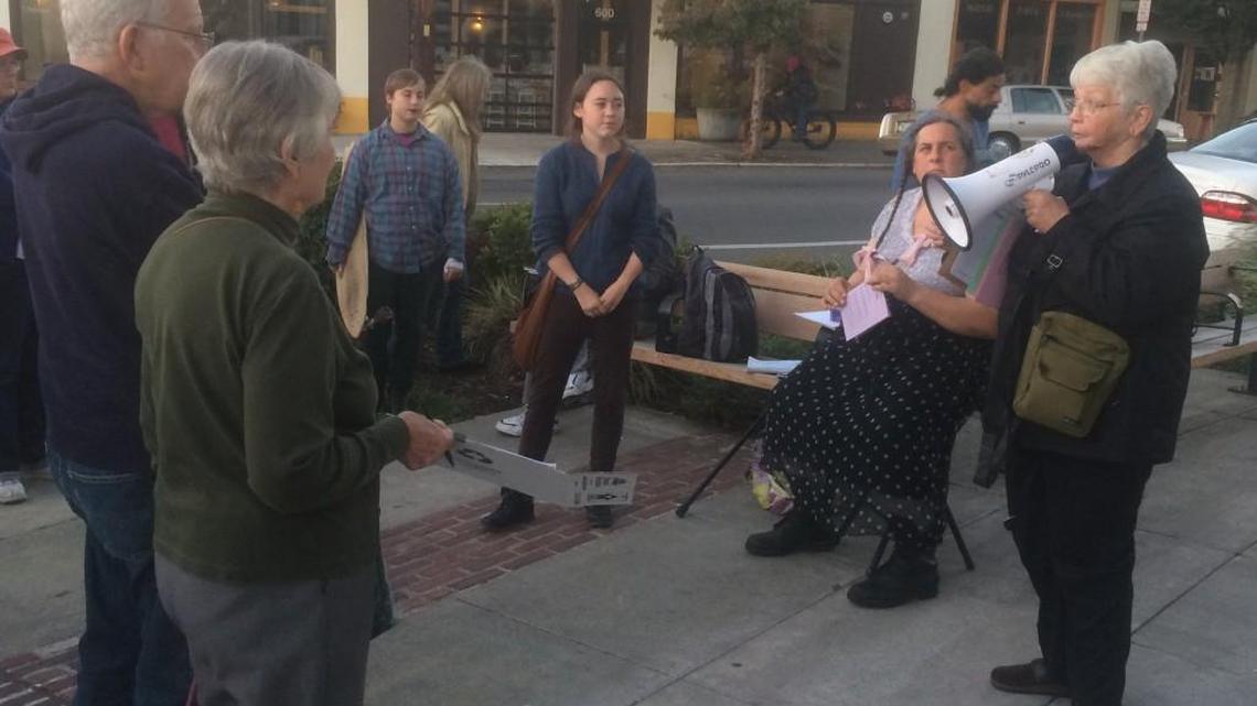 Just Housing co-organizer Selena Kilmoyer speaks Tuesday outside Olympia City Hall as part of a gathering to raise awareness about the lack of affordable housing in the area.