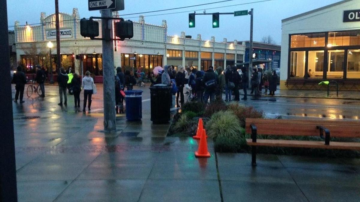 In response to the previous day's incident in which a man died during his arrest outside the Olympia Transit Center, protesters block Fourth Avenue on Tuesday evening in front of City Hall in downtown Olympia. The protest started at 5 p.m. at Percival Landing with eight people.