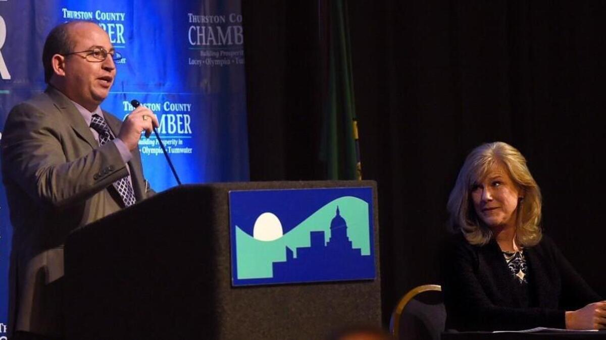 City of Yelm Mayor Ron Harding takes a light jab regarding the speech length of preceding speakers Mayor Cheryl Selby of Olympia (at right) and Thurston County Commission chair Sandra Romeo during the State of the Community panel presentation at a Thurston Chamber luncheon on Wednesday at the Red Lion Hotel Olympia.