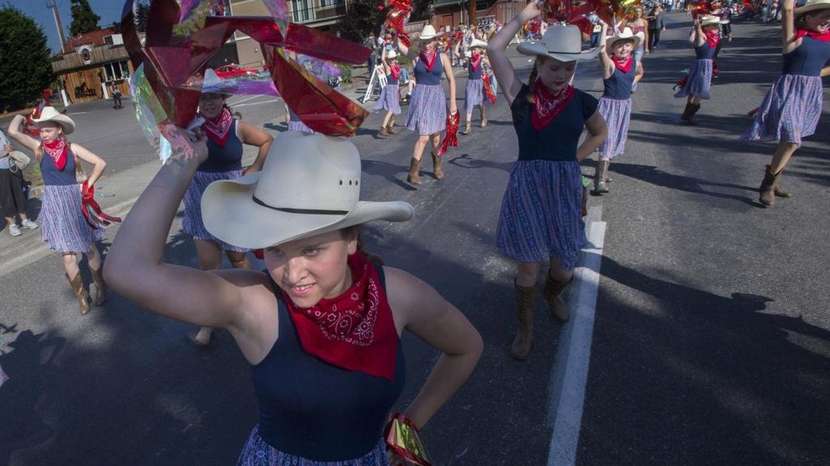 Members of the Integrity Homeschool Drill Team perform in the cattle drive and parade on Meridian to help kick off  the Washington State Fair on Friday .