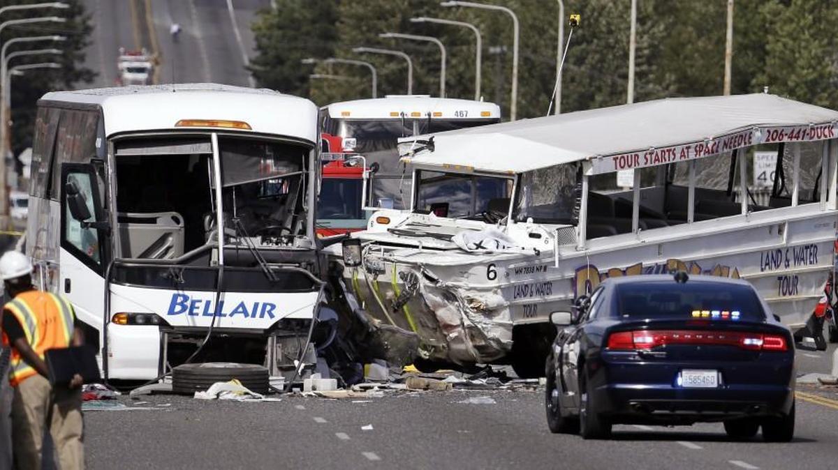 FILE - In this Sept. 24, 2015, file photo, a "Ride the Ducks" amphibious tour bus, right, and a charter bus remain at the scene of a fatal collision on the Aurora Bridge in Seattle. The tour vehicle crash, which killed four and injured dozens, was among the top stories in the state in 2015.