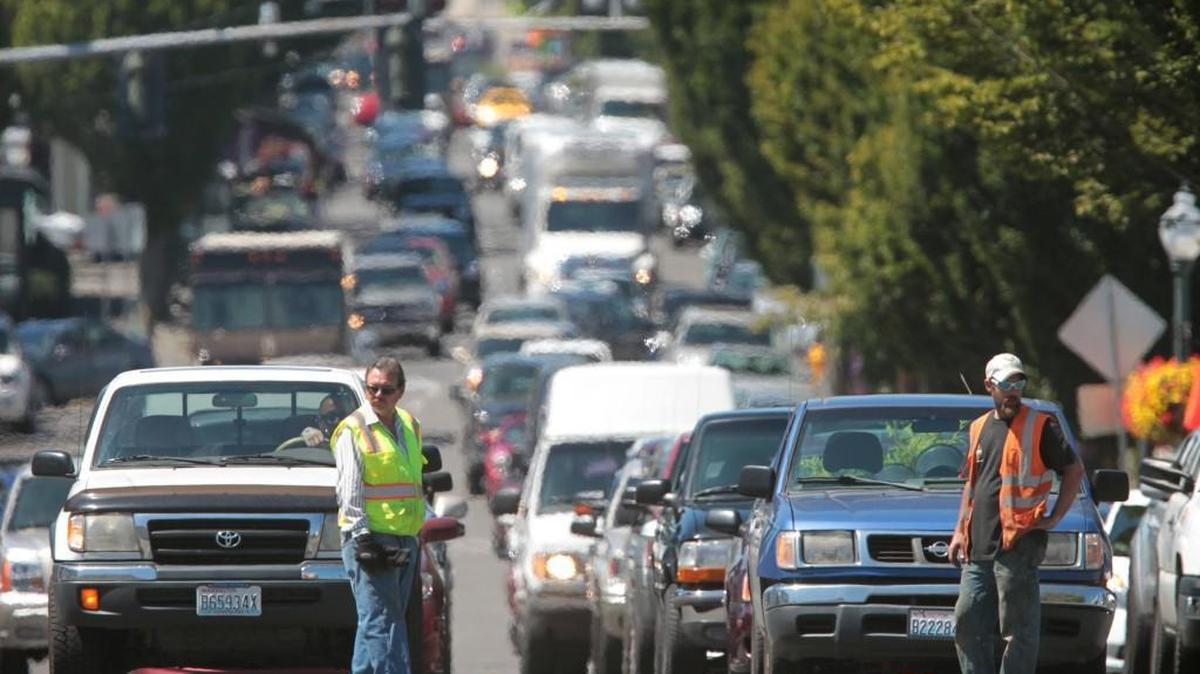 Traffic backs up all the way through downtown Olympia as public works crews prepare the roadway for repaving at the intersection of Fourth Avenue and Plum Street on Tuesday, July 23, 2013.