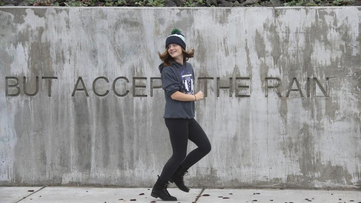 
Annie Barrette, 13, passes part of the “Walking on Land by Water” artwork by artist Carolyn Law and poet Lucia Perillo as she runs on the new sidewalk along West Bay Drive in Olympia on Friday. The addition  connects existing sidewalks from the Smyth Landing condominiums to Brawne Avenue.
