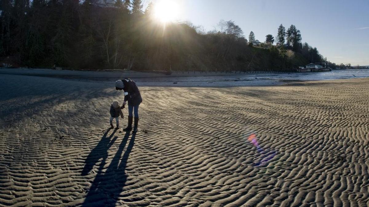 Jaclyn Martin and her daughter Lucille enjoy a brisk, clear day on the beach at Dash Point State Park in 2012. Dash Point is one of the state parks offering group hikes on Jan. 1.