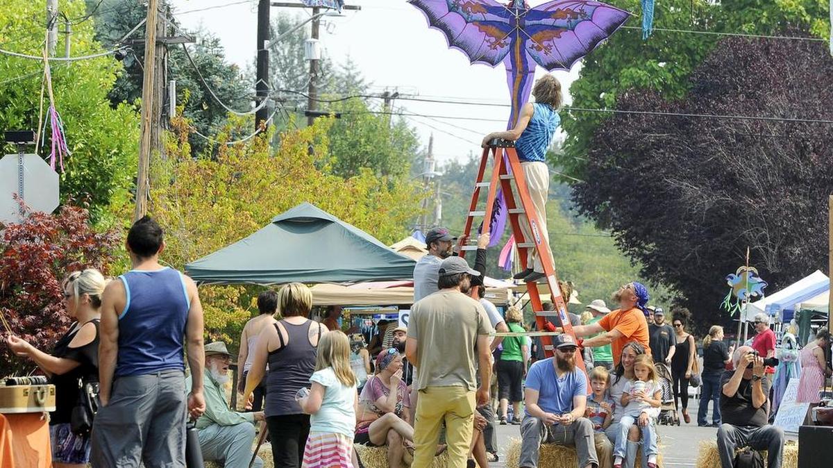 
With San Francisco Street blocked off Sunday for pedestrians, people amble along rows of vendors’ booths while music plays for this year’s Love Our Local neighborhood celebration near Roosevelt Elementary School in Olympia. 
