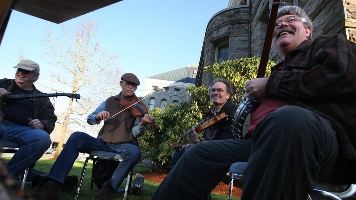Musicians, from left, Bill Boyer of Portland, John Luna of Corvallis, Scott Killops of Portland and Jim Williams of Boise jam with friends in on the lawn of the Superintendent of Public Instruction Building during the Oly Old-Time Music Festival in downtown Olympia in 2013. The event concludes with a Sunday cabaret at 3 p.m.